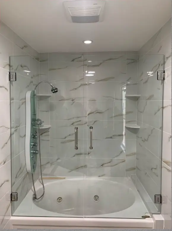 Frameless shower beside a drop-in tub