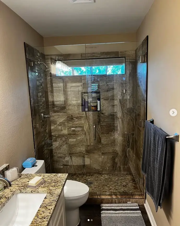 Frameless shower in a marble surround