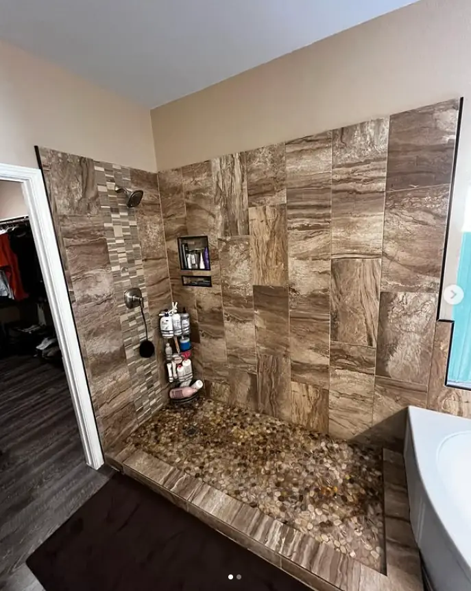 Frameless shower with stone tile